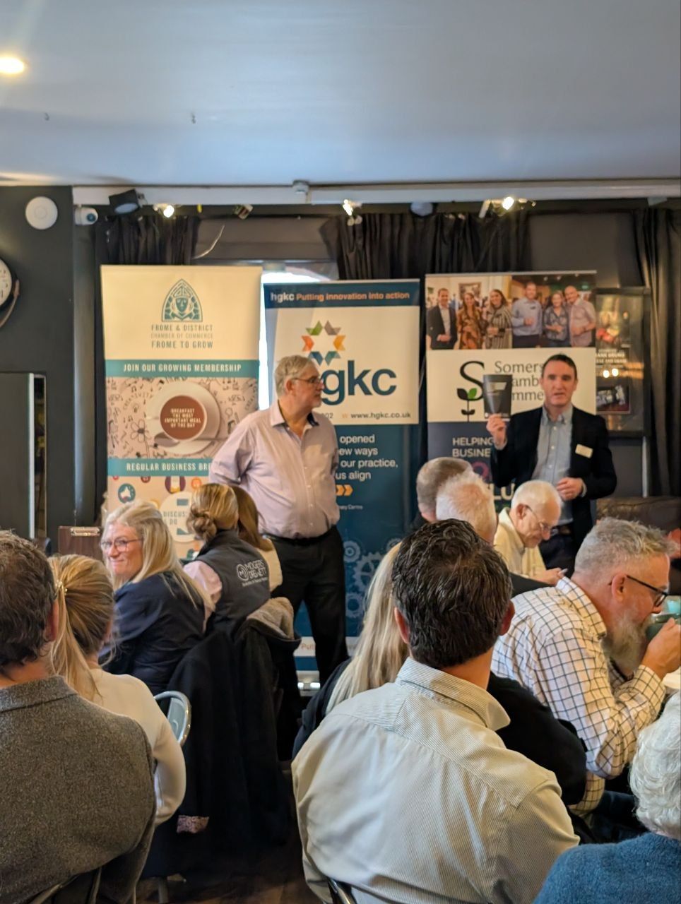 Speakers in front of Frome and District Chamber of Commerce, hgkc and Somerset Chamber of Commerce banners